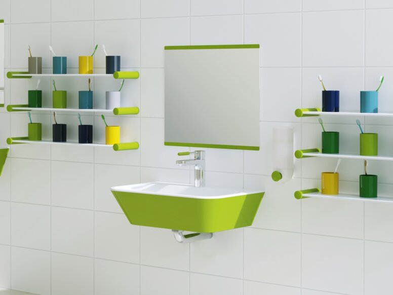 Child-friendly washbasin with green accents; two washbasins at different heights next to colourful toothbrush holders